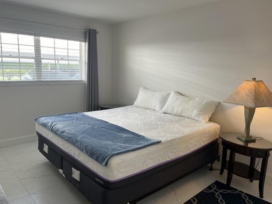 Very desirable bottom floor condo with views of the water, golf on Atlantis Golf Club in Florida - for sale on GolfHomes.com, golf home, golf lot