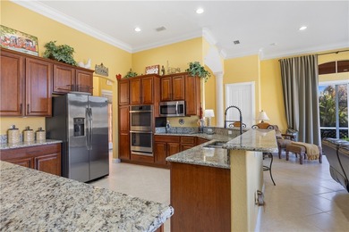 Meticulously landscaped courtyard entry, sculpted gardens and on Bent Pine Golf Club in Florida - for sale on GolfHomes.com, golf home, golf lot