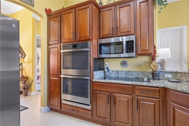 Meticulously landscaped courtyard entry, sculpted gardens and on Bent Pine Golf Club in Florida - for sale on GolfHomes.com, golf home, golf lot