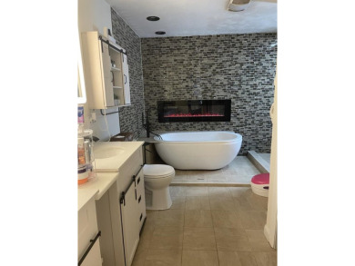 Welcome to this spacious and inviting 4-bedroom, 2.5-bath home on Paintsville Country Club in Kentucky - for sale on GolfHomes.com, golf home, golf lot