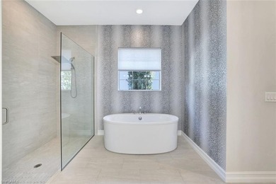 Indulge in modern luxury at this exquisite STOCK LUXURY home in on The Golf Club At Fiddlers Creek in Florida - for sale on GolfHomes.com, golf home, golf lot