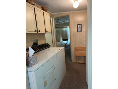 Welcome to this cozy and inviting home perfectly situated on a on Lake Henry Golf Club in Florida - for sale on GolfHomes.com, golf home, golf lot