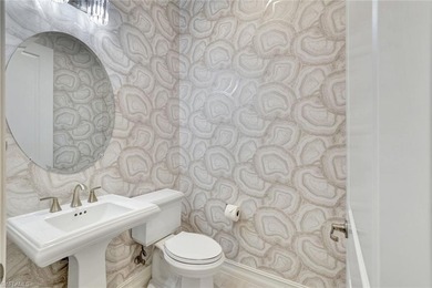 Indulge in modern luxury at this exquisite STOCK LUXURY home in on The Golf Club At Fiddlers Creek in Florida - for sale on GolfHomes.com, golf home, golf lot