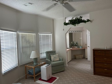 LIVING room is very spacious with bay windows, carpet flooring on Silver Dollar Golf and Trap Club in Florida - for sale on GolfHomes.com, golf home, golf lot