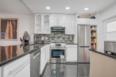 Wake up to sparkling lake views in this bright 1BR/1.5BA Palm on Palm-Aire Country Club and Resort - The Oaks in Florida - for sale on GolfHomes.com, golf home, golf lot