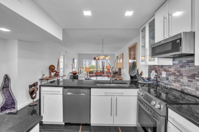 Wake up to sparkling lake views in this bright 1BR/1.5BA Palm on Palm-Aire Country Club and Resort - The Oaks in Florida - for sale on GolfHomes.com, golf home, golf lot