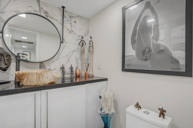 Wake up to sparkling lake views in this bright 1BR/1.5BA Palm on Palm-Aire Country Club and Resort - The Oaks in Florida - for sale on GolfHomes.com, golf home, golf lot