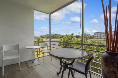 Wake up to sparkling lake views in this bright 1BR/1.5BA Palm on Palm-Aire Country Club and Resort - The Oaks in Florida - for sale on GolfHomes.com, golf home, golf lot