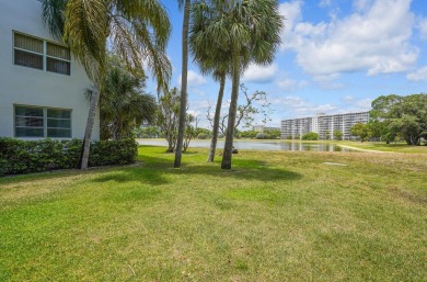 Wake up to sparkling lake views in this bright 1BR/1.5BA Palm on Palm-Aire Country Club and Resort - The Oaks in Florida - for sale on GolfHomes.com, golf home, golf lot