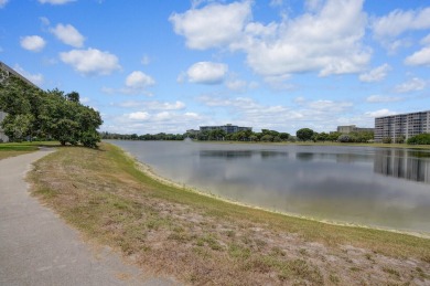Wake up to sparkling lake views in this bright 1BR/1.5BA Palm on Palm-Aire Country Club and Resort - The Oaks in Florida - for sale on GolfHomes.com, golf home, golf lot