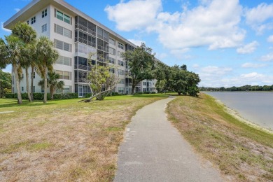 Wake up to sparkling lake views in this bright 1BR/1.5BA Palm on Palm-Aire Country Club and Resort - The Oaks in Florida - for sale on GolfHomes.com, golf home, golf lot