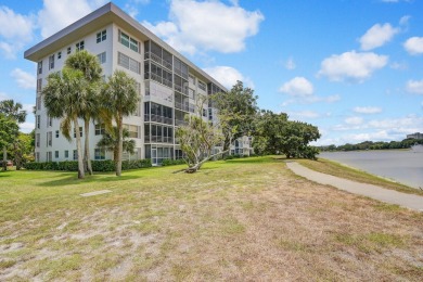 Wake up to sparkling lake views in this bright 1BR/1.5BA Palm on Palm-Aire Country Club and Resort - The Oaks in Florida - for sale on GolfHomes.com, golf home, golf lot