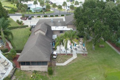 Beautiful landscaping surrounds this updated 2 bedroom 2 bath on Lake Henry Golf Club in Florida - for sale on GolfHomes.com, golf home, golf lot