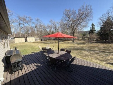 Nestled on a serene treed lot, this stunning one-story on Devils Lake Town and Country Club in North Dakota - for sale on GolfHomes.com, golf home, golf lot