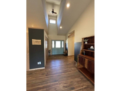 Nestled on a serene treed lot, this stunning one-story on Devils Lake Town and Country Club in North Dakota - for sale on GolfHomes.com, golf home, golf lot