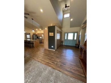 Nestled on a serene treed lot, this stunning one-story on Devils Lake Town and Country Club in North Dakota - for sale on GolfHomes.com, golf home, golf lot
