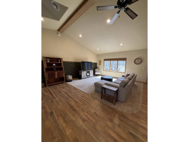 Nestled on a serene treed lot, this stunning one-story on Devils Lake Town and Country Club in North Dakota - for sale on GolfHomes.com, golf home, golf lot