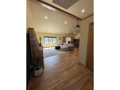 Nestled on a serene treed lot, this stunning one-story on Devils Lake Town and Country Club in North Dakota - for sale on GolfHomes.com, golf home, golf lot