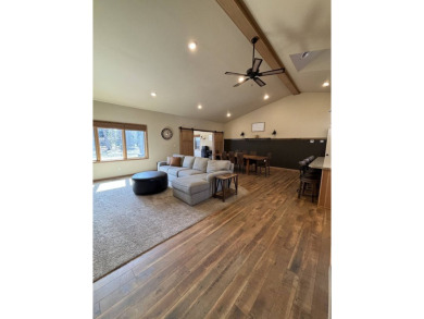 Nestled on a serene treed lot, this stunning one-story on Devils Lake Town and Country Club in North Dakota - for sale on GolfHomes.com, golf home, golf lot