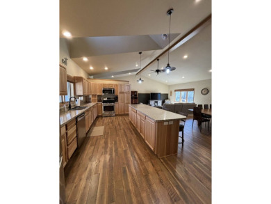Nestled on a serene treed lot, this stunning one-story on Devils Lake Town and Country Club in North Dakota - for sale on GolfHomes.com, golf home, golf lot
