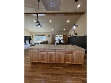 Nestled on a serene treed lot, this stunning one-story on Devils Lake Town and Country Club in North Dakota - for sale on GolfHomes.com, golf home, golf lot