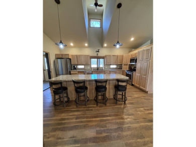 Nestled on a serene treed lot, this stunning one-story on Devils Lake Town and Country Club in North Dakota - for sale on GolfHomes.com, golf home, golf lot