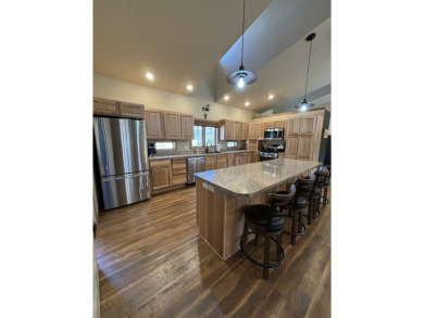 Nestled on a serene treed lot, this stunning one-story on Devils Lake Town and Country Club in North Dakota - for sale on GolfHomes.com, golf home, golf lot