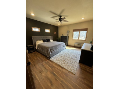 Nestled on a serene treed lot, this stunning one-story on Devils Lake Town and Country Club in North Dakota - for sale on GolfHomes.com, golf home, golf lot