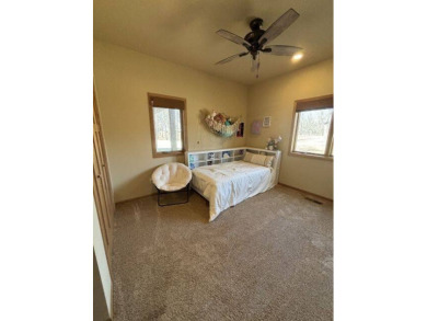 Nestled on a serene treed lot, this stunning one-story on Devils Lake Town and Country Club in North Dakota - for sale on GolfHomes.com, golf home, golf lot
