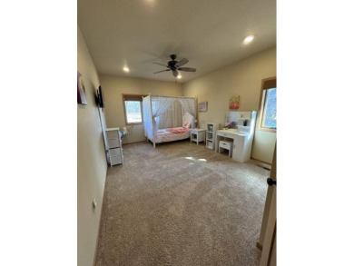 Nestled on a serene treed lot, this stunning one-story on Devils Lake Town and Country Club in North Dakota - for sale on GolfHomes.com, golf home, golf lot