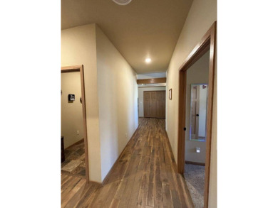 Nestled on a serene treed lot, this stunning one-story on Devils Lake Town and Country Club in North Dakota - for sale on GolfHomes.com, golf home, golf lot