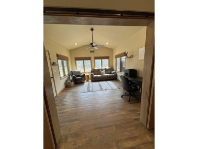 Nestled on a serene treed lot, this stunning one-story on Devils Lake Town and Country Club in North Dakota - for sale on GolfHomes.com, golf home, golf lot