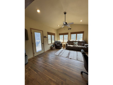 Nestled on a serene treed lot, this stunning one-story on Devils Lake Town and Country Club in North Dakota - for sale on GolfHomes.com, golf home, golf lot