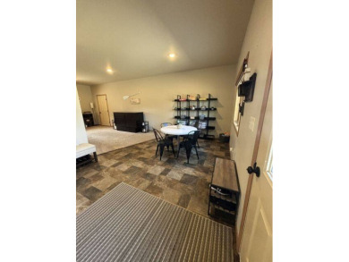 Nestled on a serene treed lot, this stunning one-story on Devils Lake Town and Country Club in North Dakota - for sale on GolfHomes.com, golf home, golf lot