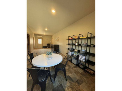 Nestled on a serene treed lot, this stunning one-story on Devils Lake Town and Country Club in North Dakota - for sale on GolfHomes.com, golf home, golf lot