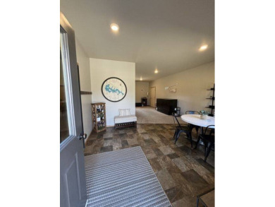 Nestled on a serene treed lot, this stunning one-story on Devils Lake Town and Country Club in North Dakota - for sale on GolfHomes.com, golf home, golf lot