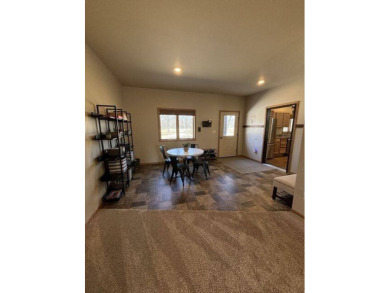 Nestled on a serene treed lot, this stunning one-story on Devils Lake Town and Country Club in North Dakota - for sale on GolfHomes.com, golf home, golf lot
