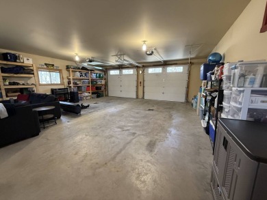Nestled on a serene treed lot, this stunning one-story on Devils Lake Town and Country Club in North Dakota - for sale on GolfHomes.com, golf home, golf lot