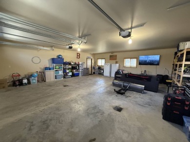 Nestled on a serene treed lot, this stunning one-story on Devils Lake Town and Country Club in North Dakota - for sale on GolfHomes.com, golf home, golf lot