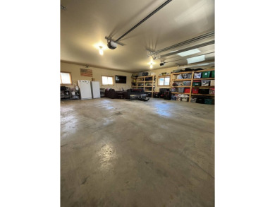 Nestled on a serene treed lot, this stunning one-story on Devils Lake Town and Country Club in North Dakota - for sale on GolfHomes.com, golf home, golf lot