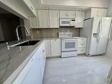 Beautifully updated second floor condo offers sweeping golf on Old Marsh Golf Club in Florida - for sale on GolfHomes.com, golf home, golf lot