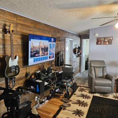 PRICE REDUCED!!!   Cozy living room with beautiful shiplap wall on Golden Lakes Golf Course in Florida - for sale on GolfHomes.com, golf home, golf lot