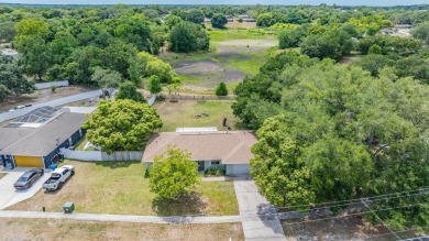Welcome to this beautifully maintained 3-bedroom, 2-bathroom on Oak Hills Country Club in Florida - for sale on GolfHomes.com, golf home, golf lot