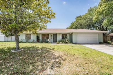 Welcome to this beautifully maintained 3-bedroom, 2-bathroom on Oak Hills Country Club in Florida - for sale on GolfHomes.com, golf home, golf lot