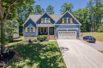 Resort-style living awaits in this beautifully crafted 2023 on River Golf and County Club at Lake Royale in North Carolina - for sale on GolfHomes.com, golf home, golf lot