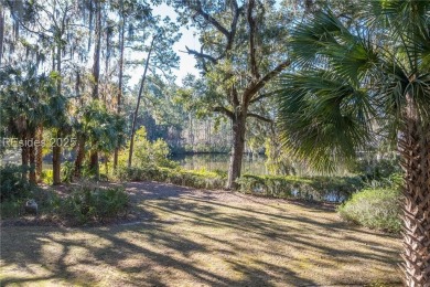 Enjoy the incredible sunset views of a large lagoon and bird on Callawassie Island Club in South Carolina - for sale on GolfHomes.com, golf home, golf lot