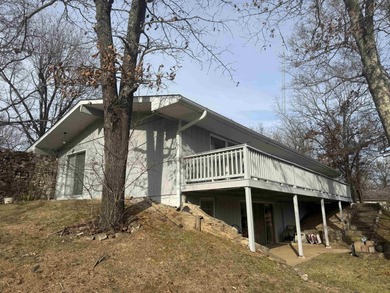 This charming 3-bedroom, 2.5-bath home sits on Lake Omaha in on Cherokee Village South Course in Arkansas - for sale on GolfHomes.com, golf home, golf lot