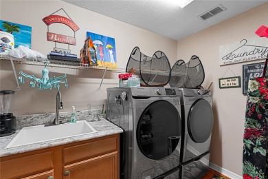 Discover a remarkable 4-bedroom, 3-bathroom pool home in the on Hunters Green Country Club in Florida - for sale on GolfHomes.com, golf home, golf lot