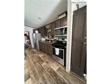 This cozy  2 bedroom, 2 bath mountain escape in Linviille Land on Land Harbor Golf Course in North Carolina - for sale on GolfHomes.com, golf home, golf lot