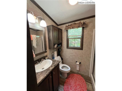 This cozy  2 bedroom, 2 bath mountain escape in Linviille Land on Land Harbor Golf Course in North Carolina - for sale on GolfHomes.com, golf home, golf lot